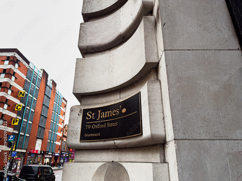 Fototapeta premium Historic St James Oxford St plaque on ornate stone arch near Manchester building in the city center
