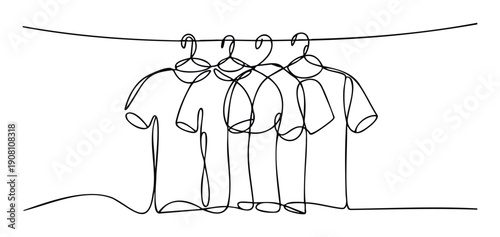 Continuous line drawing of four tshirts hanging on clothes hangers from a clothesline, ideal for showcasing simplicity in apparel or textile industry advertising.