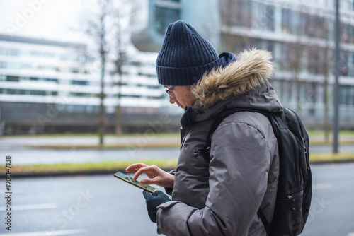 Close up. Portrait of a male tourist using a smartphone to find his way.