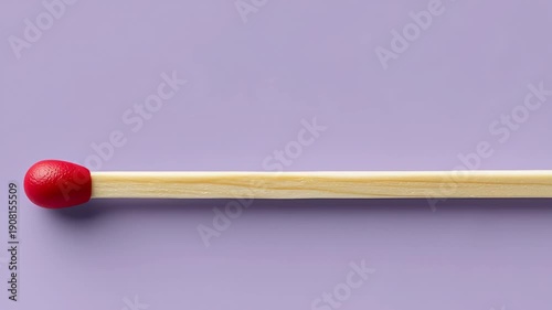 Close-up sequence of wooden matchstick with red head resting on a purple background, showcasing the matchstick's details and texture in three consecutive frames