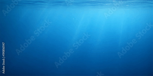 Sunlight rays pierce the deep blue ocean surface to illuminate an abstract underwater scene of bubbles and ripples in a vast liquid landscape