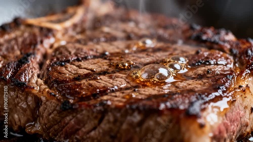 Juicy grilled beef steak sizzling close-up