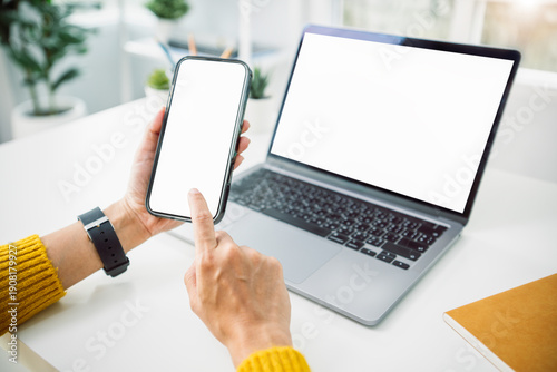 Canvastavla Asian business woman using mockup smartphone and laptop at home office concept o