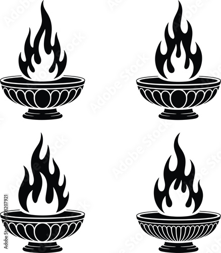 Four traditional diya lamps with lit flames in decorative bowls