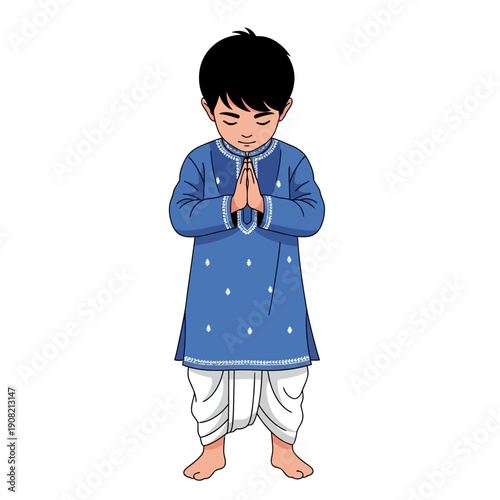 Young Indian boy in blue kurta and white dhoti greeting with folded hands (Namaste)