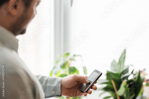 Young man intentionally using a dumbphone for digital detox and reducing screen time.