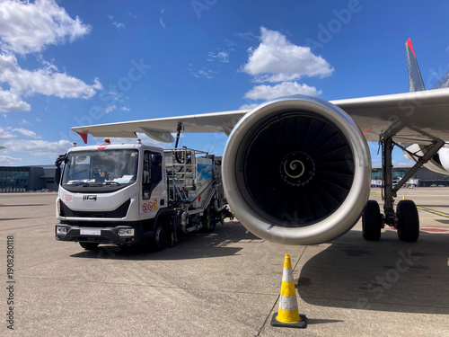 Photos Commercial Airplane Refueling on Brussels Airport Tarmac Under Blue Sky