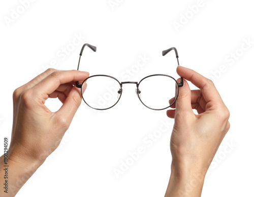 Hands holding round black metal frame eyeglasses