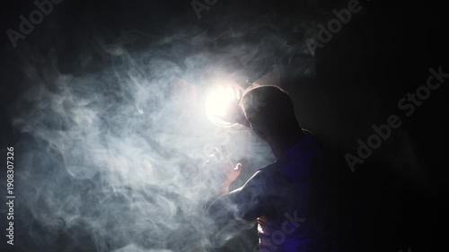 Man's hand reaching for powerful light beam