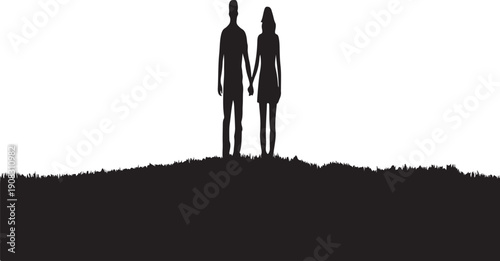 Silhouette of a couple standing on a hilltop at sunset