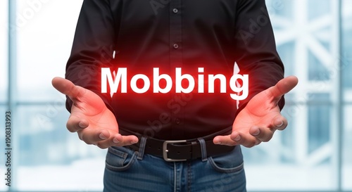 A man in a black shirt holding mobbing concept