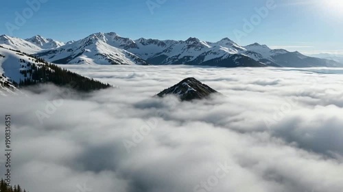 Wallpaper Mural Majestic snow-capped mountains emerge from a sea of clouds under a clear blue sky. Torontodigital.ca