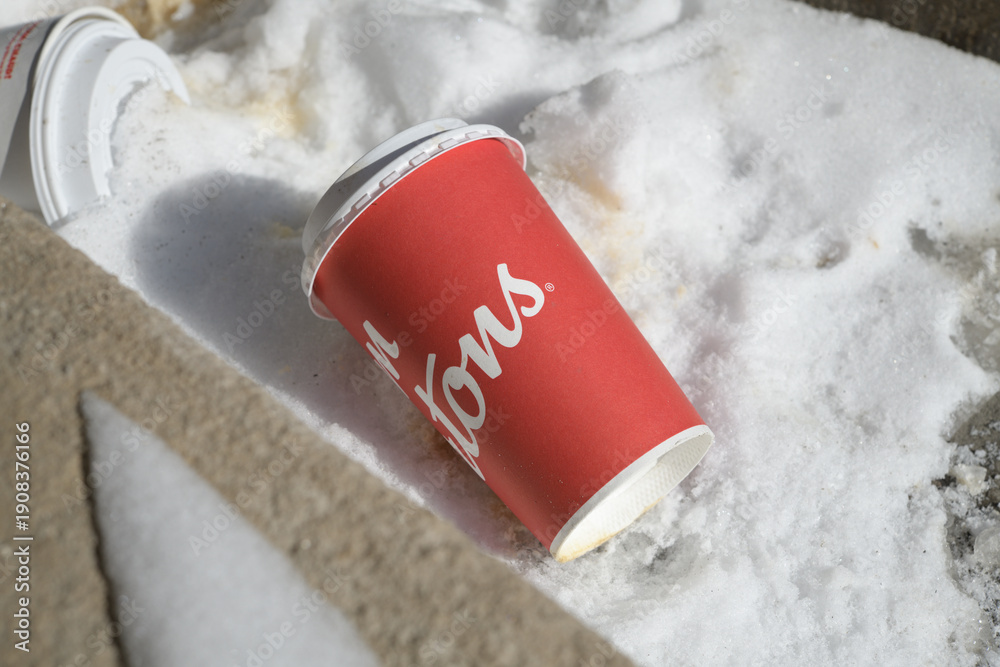 Fototapeta premium discarded Tim Hortons beverage cup on the snow, Toronto