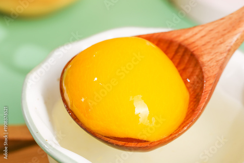 Tableau sur toile Fresh Raw Egg Yolk in Wooden Spoon - Natural Cooking Ingredient