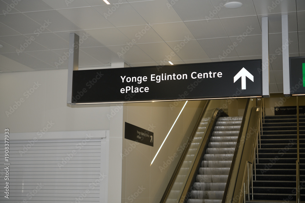 Fototapeta premium suspending sign with direction to Yonge Eglinton Centre and ePlace inside Line 5/Eglinton Line station, Toronto