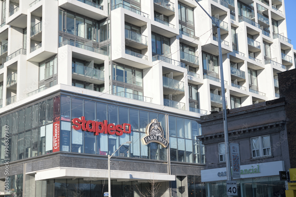 Fototapeta premium Staples and Farm Boy signs on the exterior 2149 Yonge St grade level of Art Shoppe Lofts + Condos, Toronto
