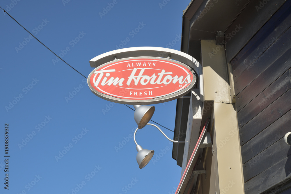 Fototapeta premium oval projecting sign outside Tim Hortons, a coffee shop chain, located here at 91 Danforth Av, Toronto