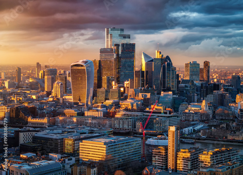 Photography Aerial view of the City skyline of London, UK; during a golden sunset with sunli