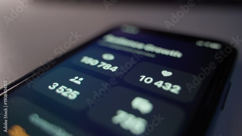 Smartphone screen showing statistics on the number of followers and likes, close-up