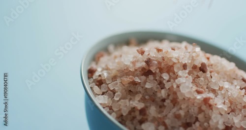 Video of himalayan salt in a bowl on blue background