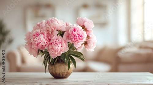 Beautiful Bouquet of Pink Peonies in a Golden Vase on a Table.