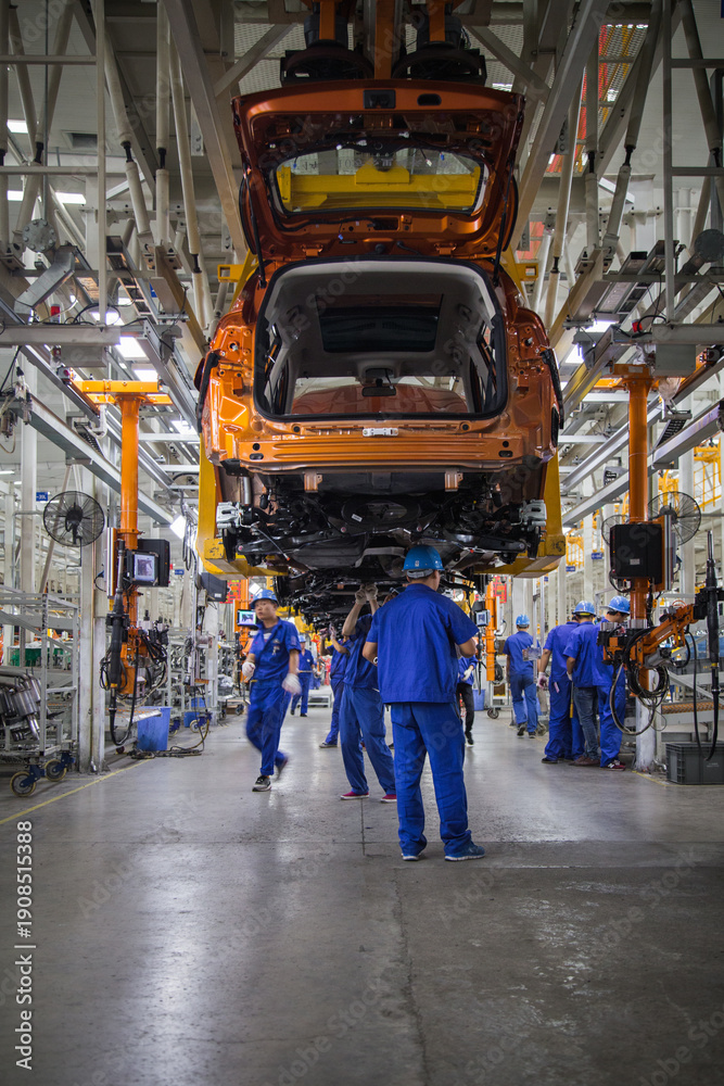 Obraz premium Automobile Assembly Line Factory Workers in Modern Industrial Workshop
