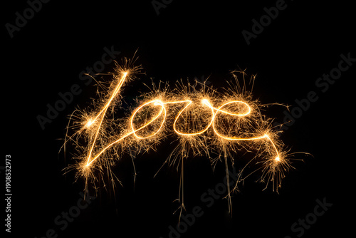Fotografia 2024 New Year Sparkler Fireworks on Black Background