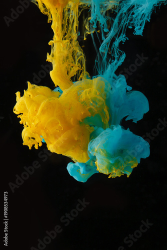 Dissolving Yellow and Cyan Pigments in Water on Black Background