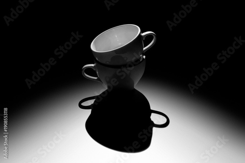 Black coffee cup lighted with opposite light source