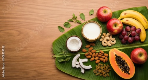 Wallpaper Mural colorful tropical fruits and nuts arranged on banana leaf with wooden background Torontodigital.ca