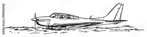 light propeller aircraft parked on field