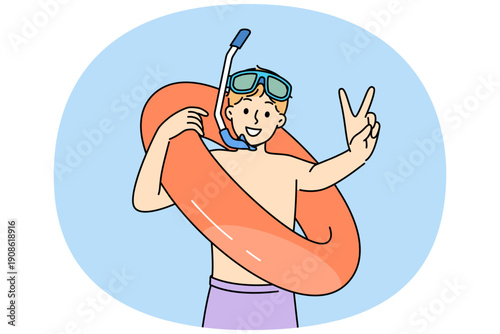 Little boy who loves to swim in pool with inflatable ring shows V gesture and looks at screen with smile. Teenage child comes to water park to swim and greets friends, anticipating fun.