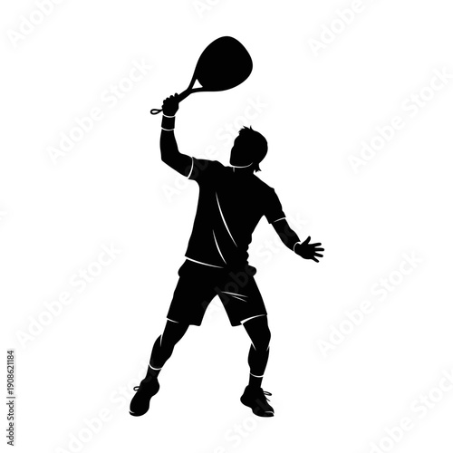Silhouette of a male tennis player serving a ball with a racket, dynamic action shot