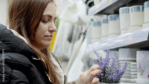 Canvastavla Shopper choosing a lavender plant in the homeware aisle of a supermarket, with s