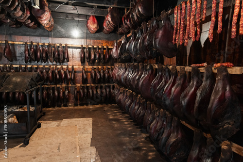 Wallpaper Mural Dark interior scene of a meat-curing cellar with rows of hams Torontodigital.ca