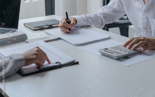 Canvastavla financial officer checking calculator with paper documents to review business an