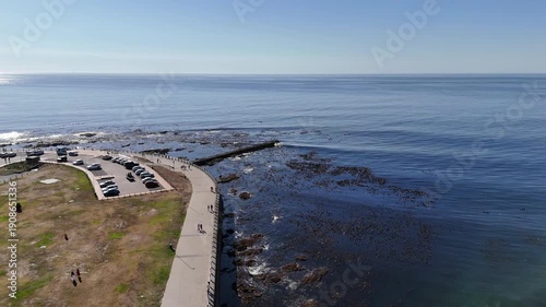 Drone flies west along Sea Point Promenade in Green Point, on a sunny day in Cape Town, South Africa