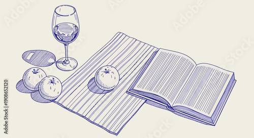 An open book lies on a table with a glass and fruit nearby in a simple still life setup viewed from above