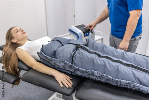 Photos Doctor starts pressotherapy for woman in rehab room