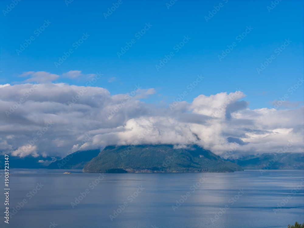 Obraz premium Calm Blue Waters Over Cloudy Mountains in Howe Sound, BC, Canada at Dawn