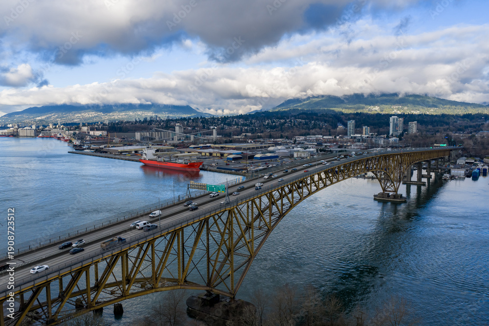 Fototapeta premium Burnaby Harbour Bridge Over Water With City Skyline and Mountain View, Vancouver Area