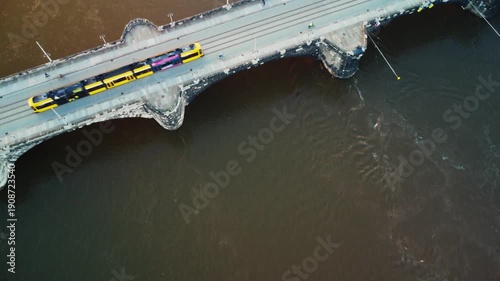 Slow-motion aerial view of trams and pedestrians moving across Dresden's Augustus Bridge
