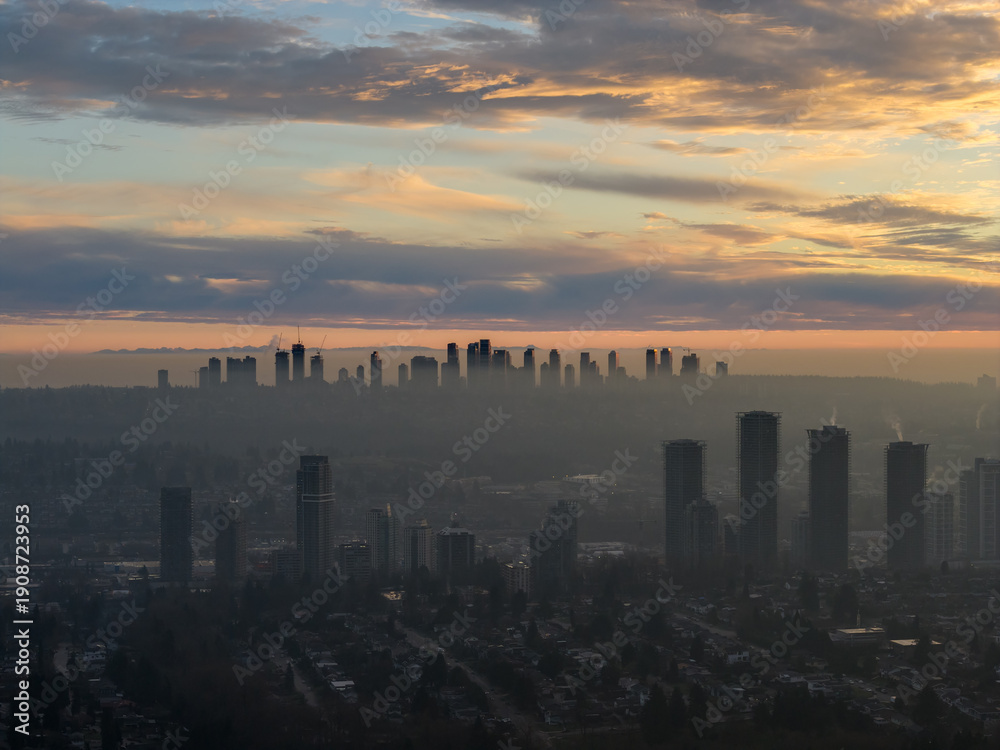 Fototapeta premium Dusk City Skyline Over Foggy Burnaby, BC With Silhouetted Towers and Soft Sunrise Colors