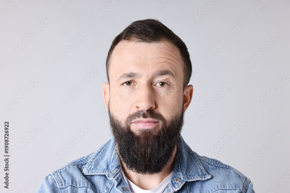 Obraz premium Man with mustache and beard on light grey background