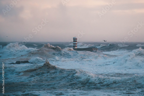 Photos Red and white lighthouse in the middle of a stormy ocean with huge waves