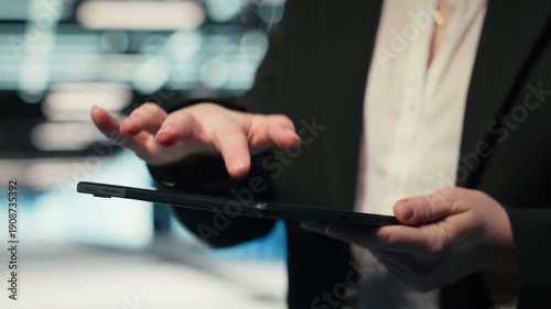 Close up of data center cybersecurity analyst using tablet to conduct security audit on IT infrastructure. Server hub professional verifying firewall settings on device, camera B