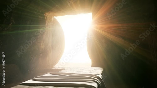Empty tomb with stone rolled away and light shining through. 4K video about the Passion of Christ, Easter.
