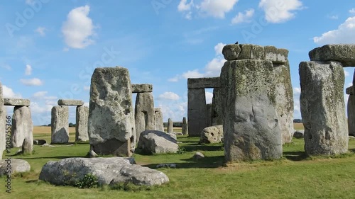 Majestic Stonehenge prehistoric monument under a bright blue sky in Wiltshire, England