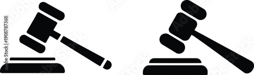 Two black courtroom gavels resting on sounding blocks illustrating justice and legal authority