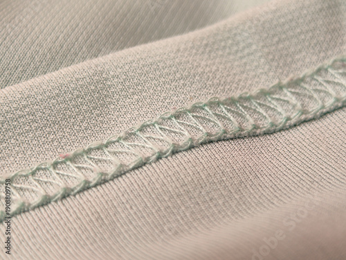 Quadro em tela This is a close-up of a mint green shirt fabric with a teal overlock stitch seam